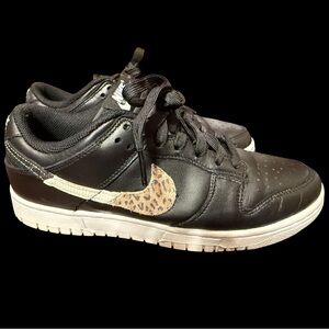 Clean pair of Nike Dunks with leopard print swoosh.